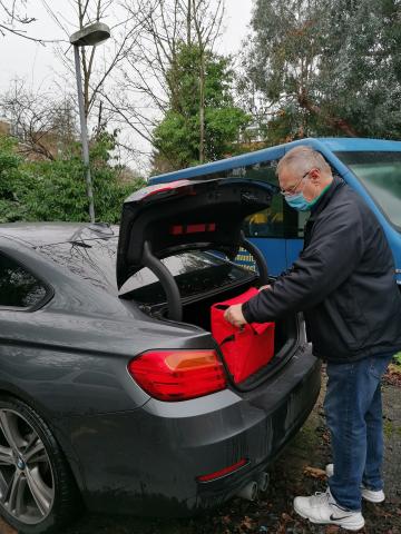 One man delivering hot meals for families at Christmas.