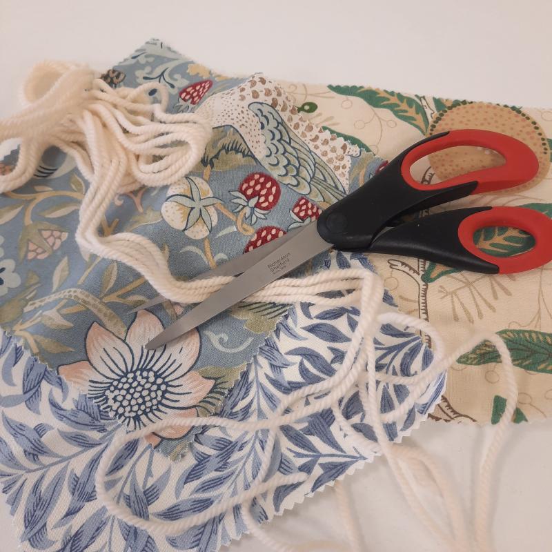 Scissors, assorted materials and yarn.